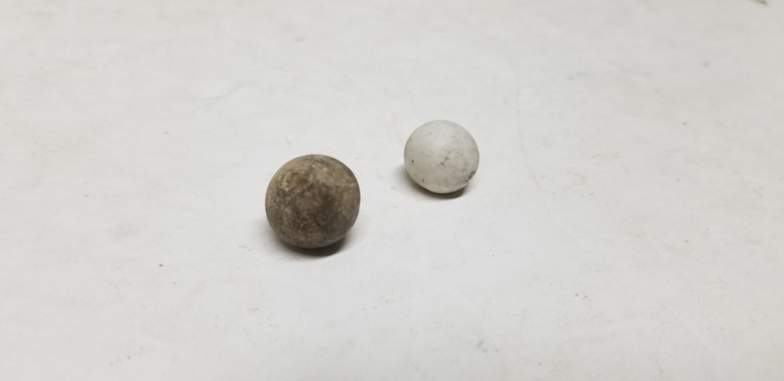 2 ANTIQUE STONEWARE MARBLES