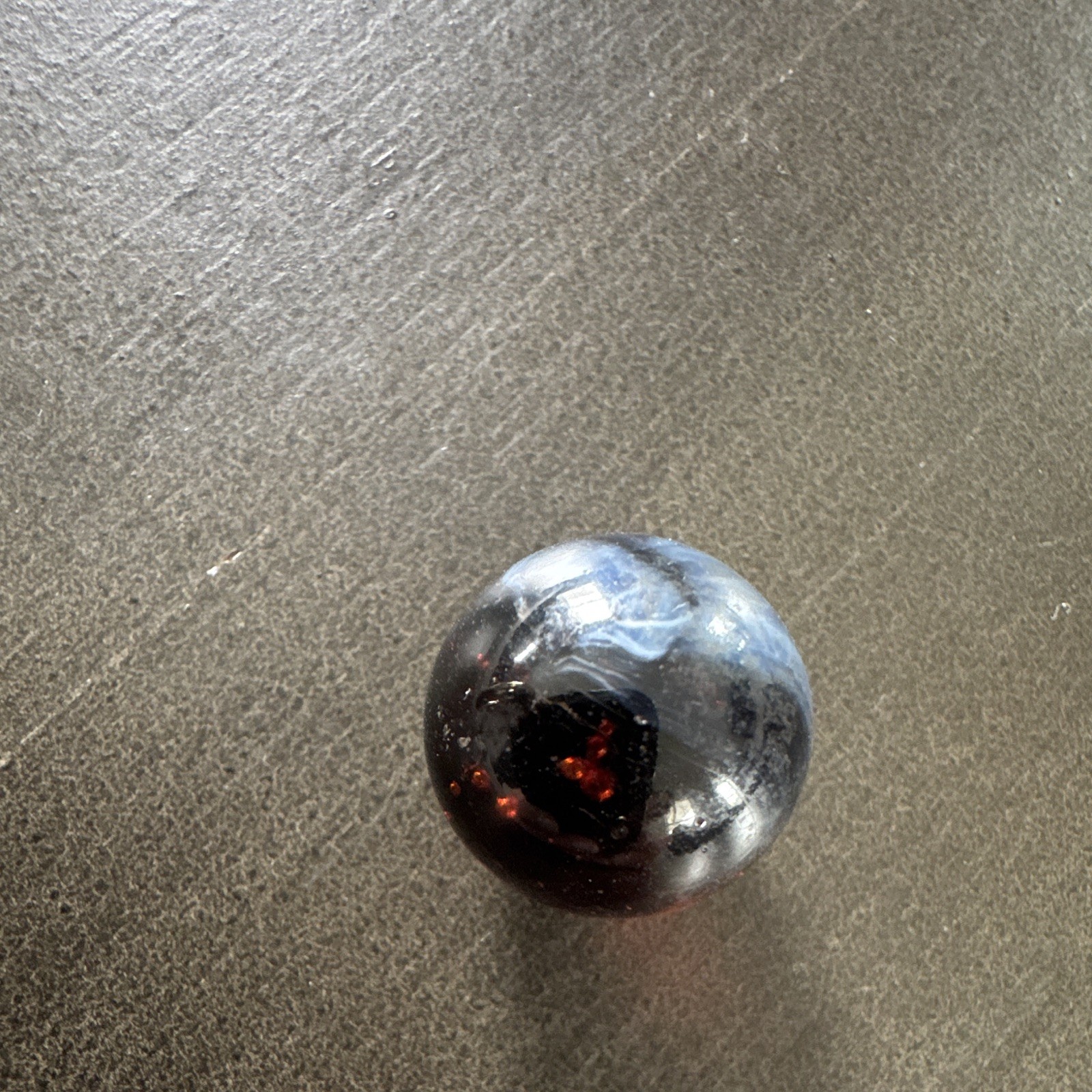 Marble. Rare looking. Glass swirl style. Dark blue/black with red.
