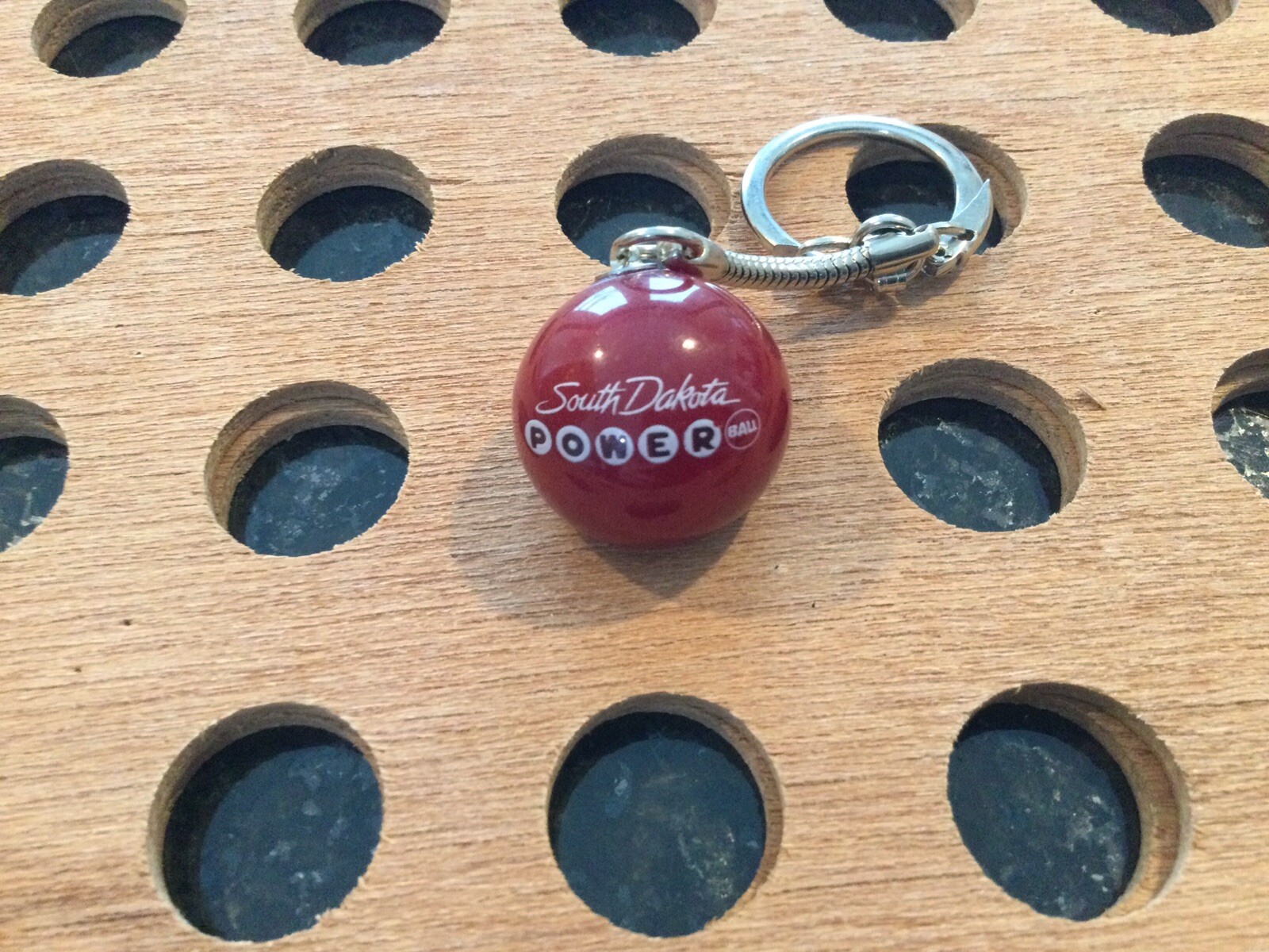 Vintage |”South Dakota Powerball”| White & Black Print on Red Marble Keychain