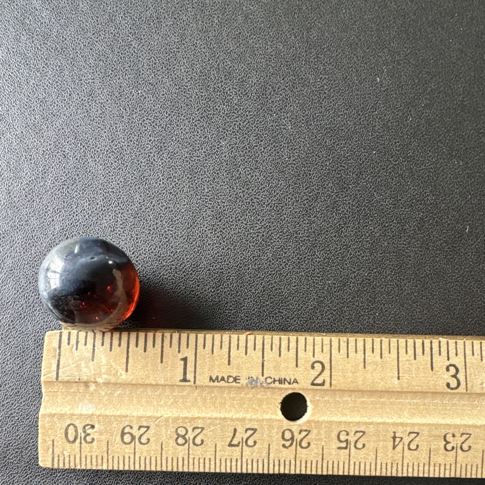 Marble. Rare looking. Glass swirl style. Dark blue/black with red.