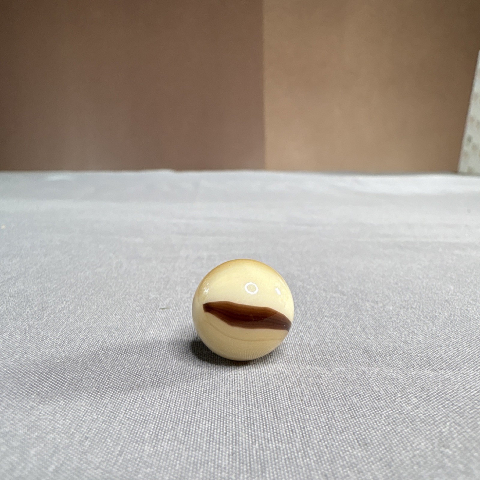 Cream & Brown Swirl Pattern Glass Toy Marble Single Piece, machine pressed