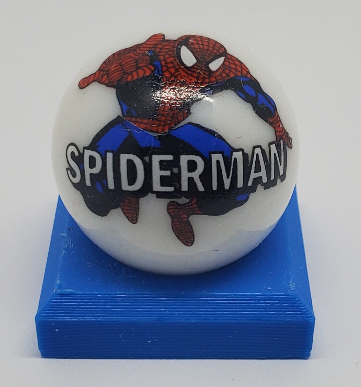Spiderman Glass 1″ Logo Marble w/ Colored Stand